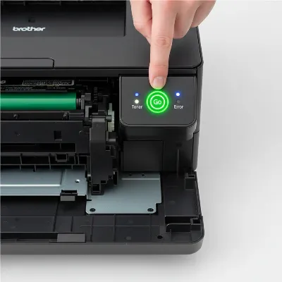 Hand pressing the 'Go' button on a Brother HL series printer with the front cover open to illustrate a toner reset procedure
